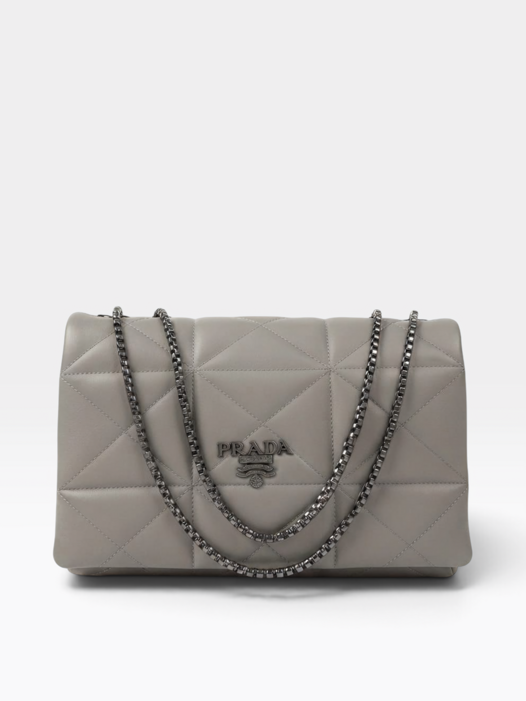 A Prada quilted shoulder bag in light gray leather with a silver-tone chain strap and a central Prada logo plaque, photographed against a clean white background.