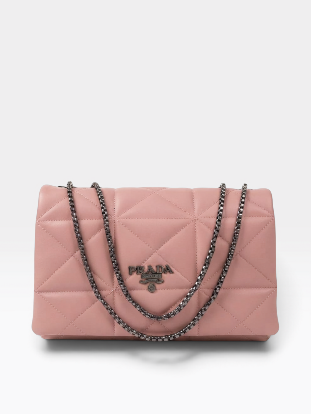 A pink quilted Prada shoulder bag with a silver-tone chain strap and a silver-tone metal logo plaque on the front, set against a plain light gray background.
